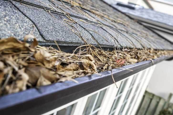A diagram or illustration showing the path of water from a clean gutter away from the house's foundation