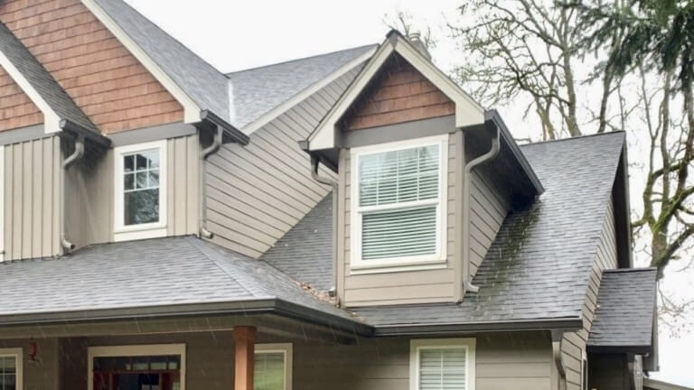 A picture of a professional gutter contractor talking to a homeowner