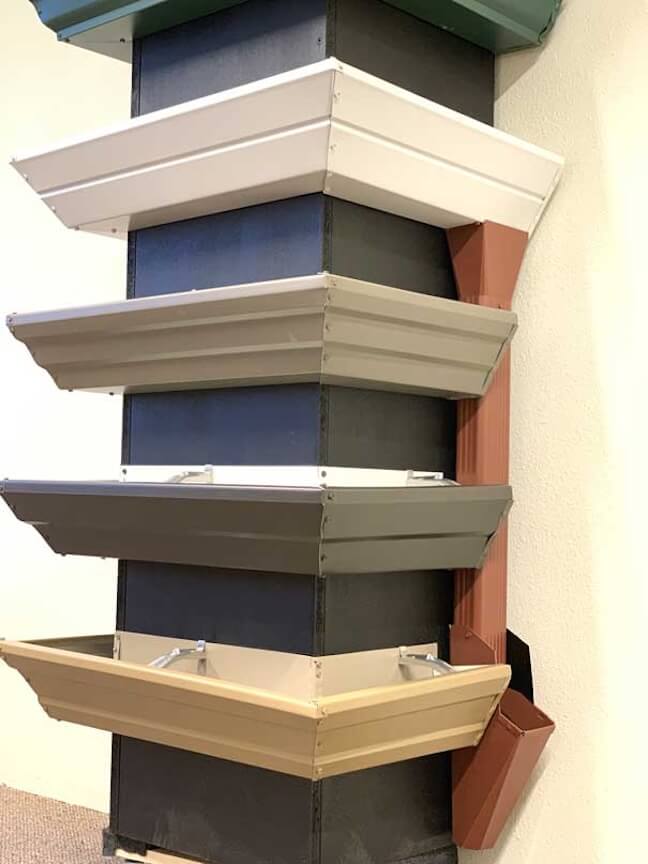 A split image showing a vinyl gutter on one side and an aluminum gutter on the other