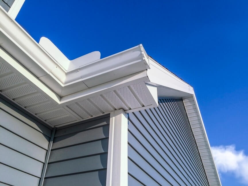 A picture of a well-maintained gutter and downspout system on a house