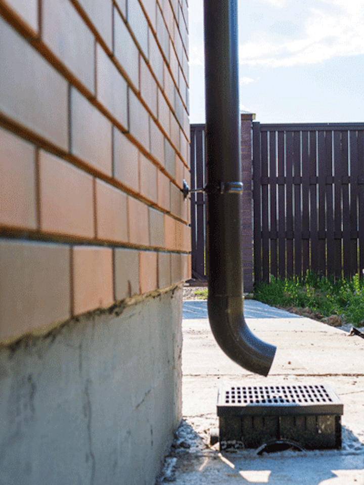 Gutter and downspout extensions installed on a house