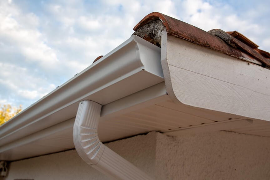 A close-up shot of a seamless gutter with an installed end cap