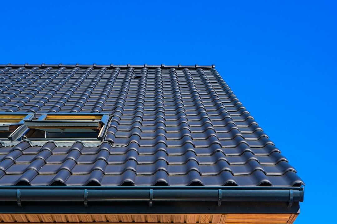 Different types of gutter hangers installed on a house roofline