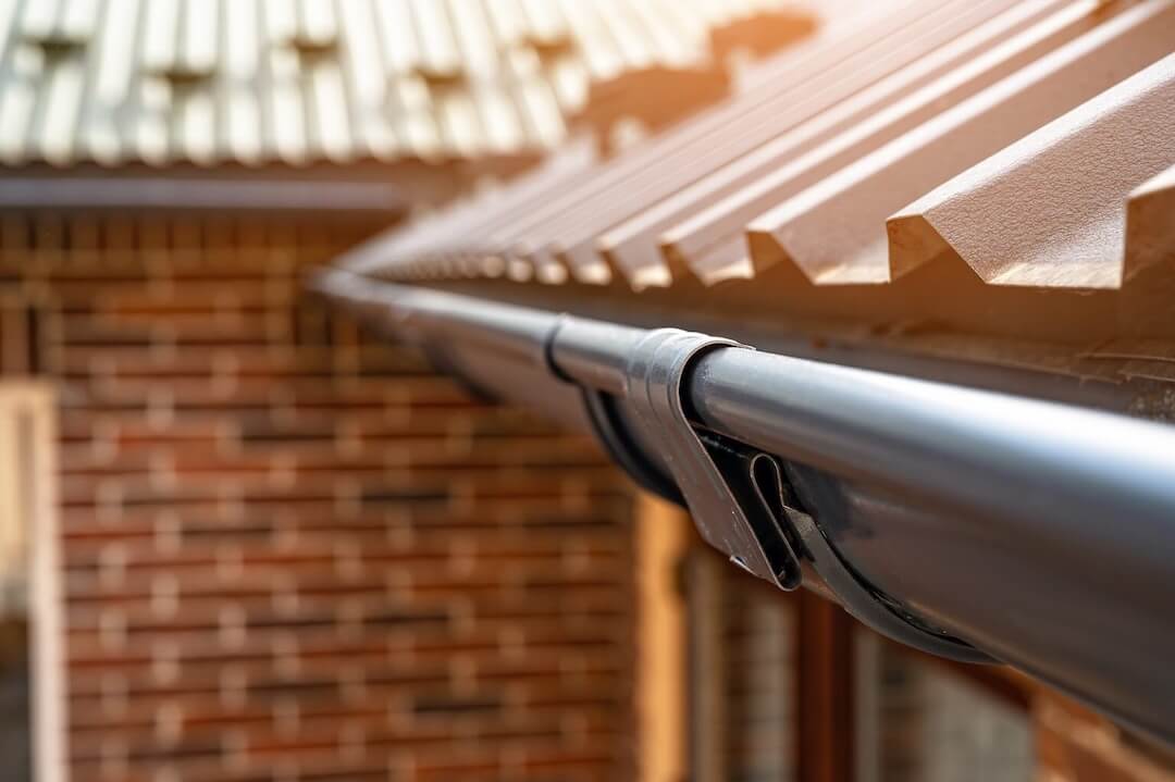 House with gutters for metal roofs showing proper installation