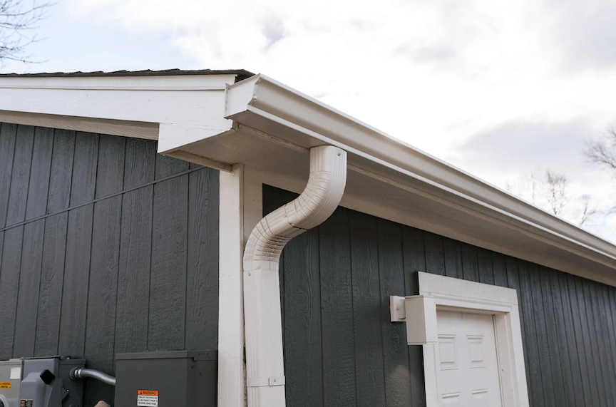 A picture of a house with a newly installed second downspout